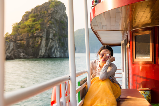Girl enjoying the last sunshine on a cruise boat
