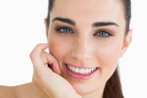 istock Woman with clear eyes looking at camera and smiling 828058802