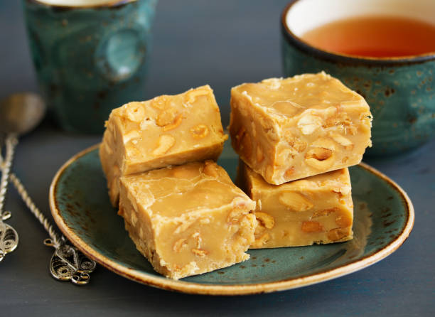 Homemade milk fudge with roasted peanuts. Homemade milk fudge with roasted peanuts.Homemade milk fudge with roasted peanuts. cocoa beach photos stock pictures, royalty-free photos & images