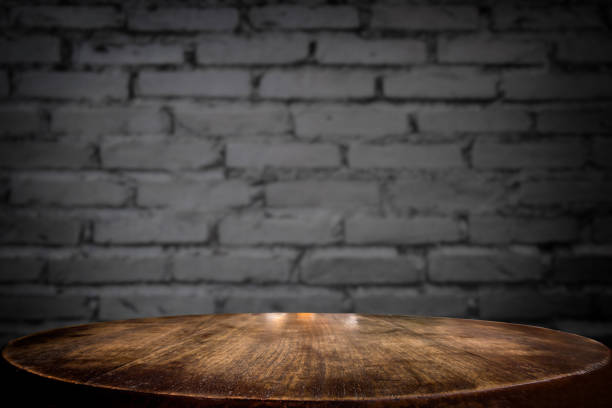 istock Selected focus empty brown wooden table and wall texture or old black brick wall blur background image. for your photomontage or product display 828073530