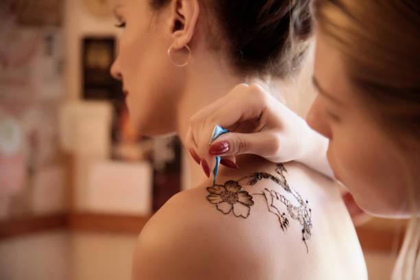 istock Girl drawing with henna for client 828078226