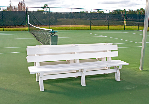 istock White bench on a tennis court 828078710