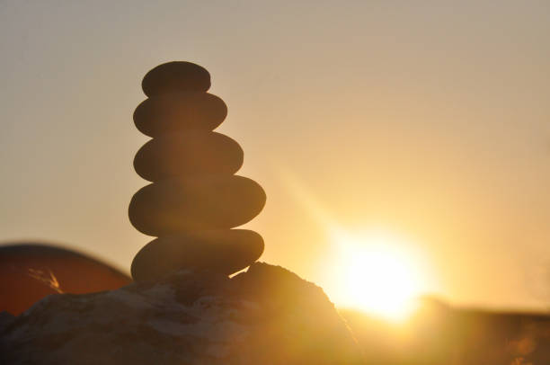 istock Silhouette of balanced stone pyramid on mountain. 828078844