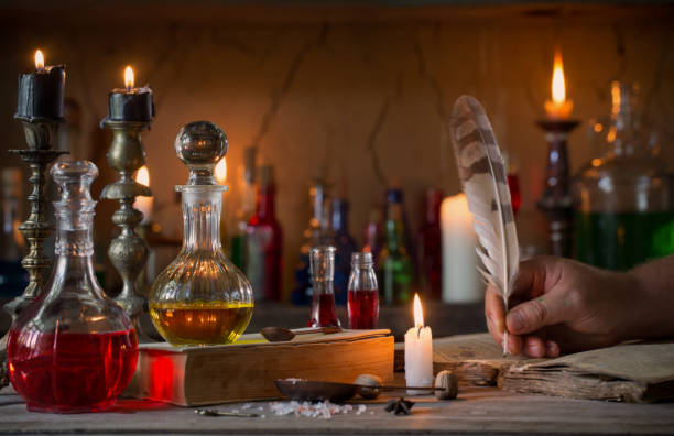 hand, magic potion, ancient books and candles - old laboratory alchemy alchemist imagens e fotografias de stock