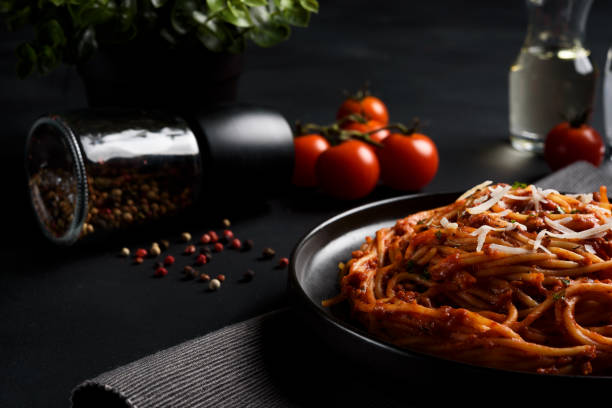 istock Spaghetti pasta with tomato sauce ,fresh tomato and cheese on dark background, selective focus 828091736