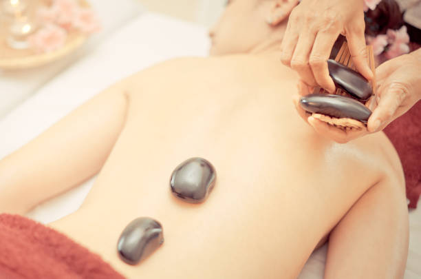 istock Women is getting thai style hot stone Spa treatment 828092342
