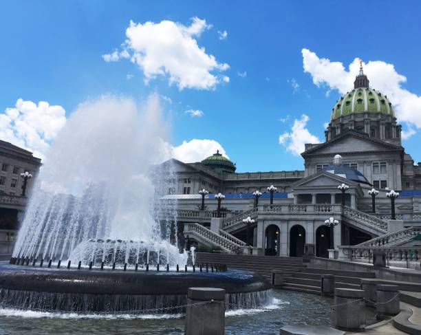 State Capitol Building in Harrisburg, Pennsylvania Image of the granite Capitol building And fountain from the soldiers green entrance harrisburg pennsylvania photos stock pictures, royalty-free photos & images