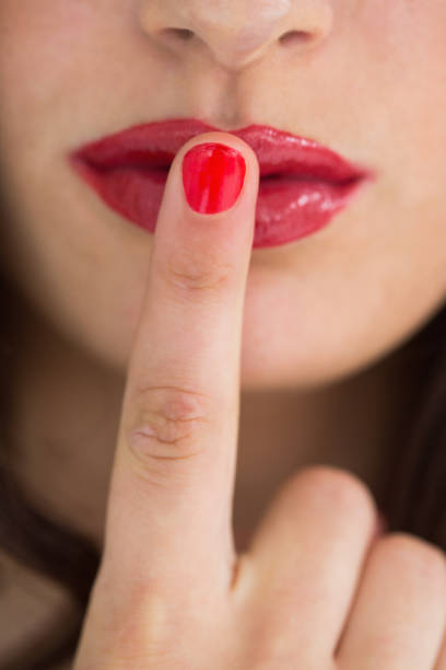 istock Woman touching her red lips with red nail 828102238