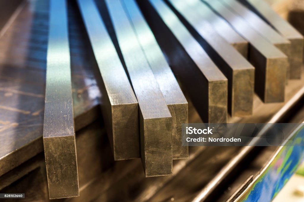 Straight row of metal bars after grinding Straight row of metal bars after grinding. Metalworking. Steel Stock Photo