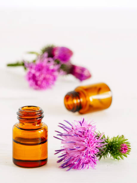 istock burdock oil in small glass bottle 828102848