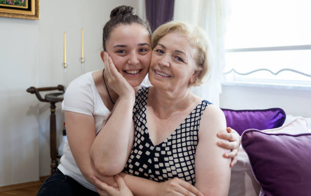 istock Smiling mother and young daughter posing to camera 828110236