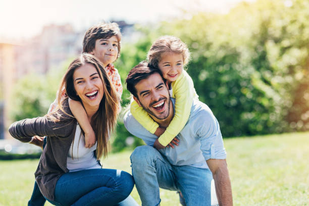 istock Piggyback with mom and dad 828121506