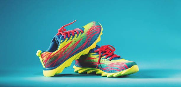 istock Colorful running sneakers on a blue background 828122284