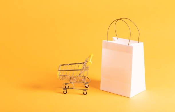 istock Shopping theme with gift bag with shopping cart 828122454