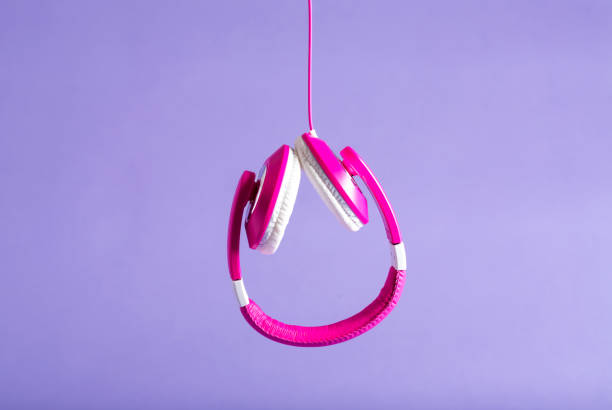 istock Pink headphones on a purple background 828122680