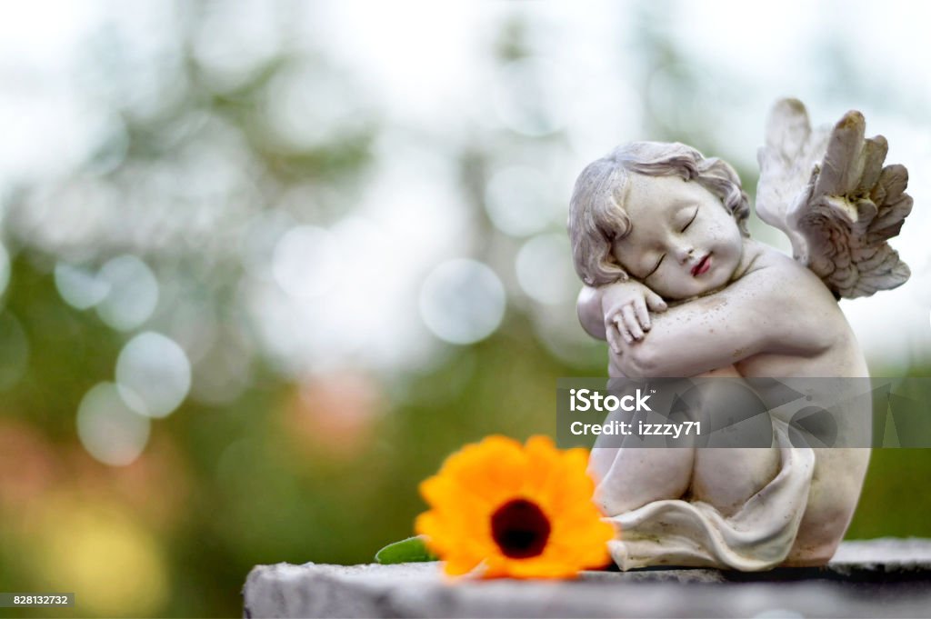 Angel guardian sleeping on the grave Child Stock Photo