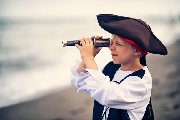 istock Funny little pirate looking with spyglass the wrong way 828132848