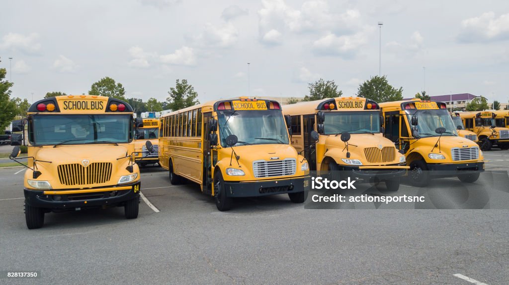 School Busses Parked At School School buses prepare for another school year. Stationary Stock Photo