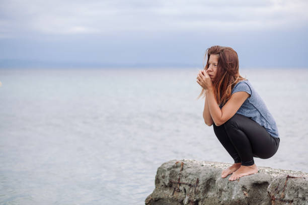 istock Woman alone and depressed at seaside 828140244