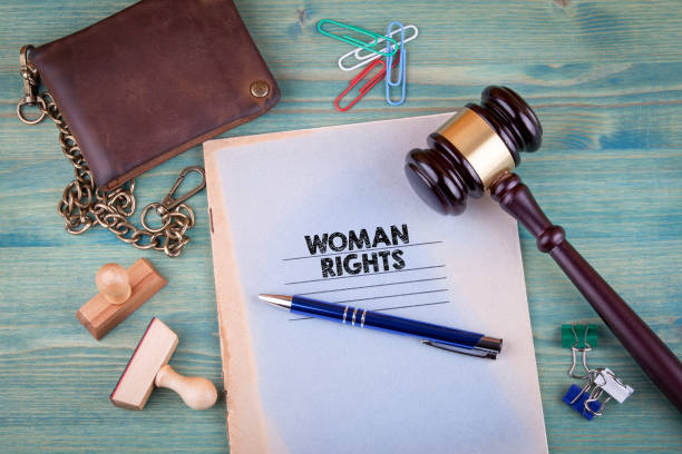 Woman Rights concept. Notebook on a bright green background. Office stationery accessories
