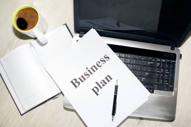 istock An inscription of the business plan, execution points, there is a notebook and a calculator next to it 828154744