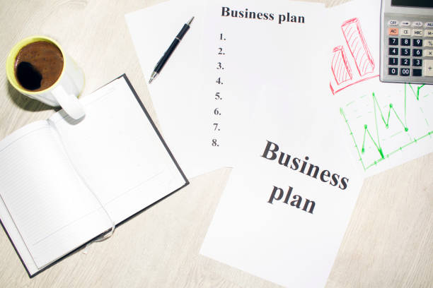 istock An inscription of the business plan, execution points, there is a notebook and a calculator next to it 828154878