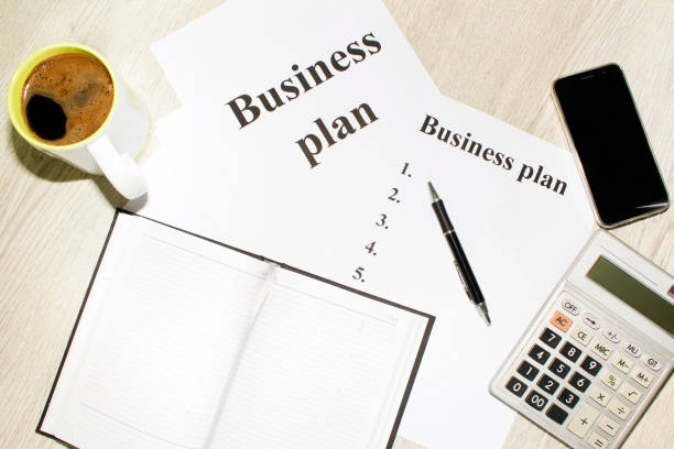 istock An inscription of the business plan, execution points, there is a notebook and a calculator next to it 828154906
