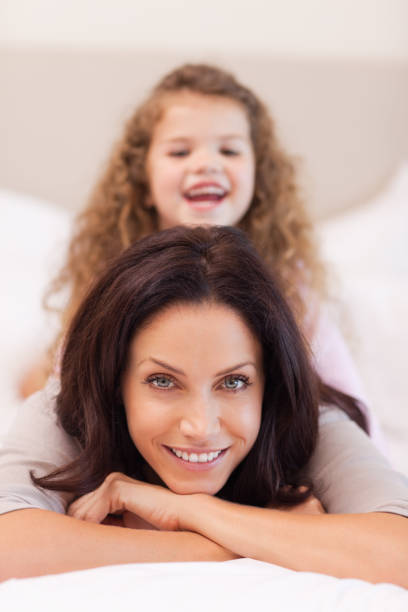 istock Girl enjoys sitting on her mothers back 828167380
