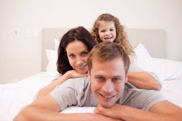 istock Playful family spending time in the bedroom 828167492