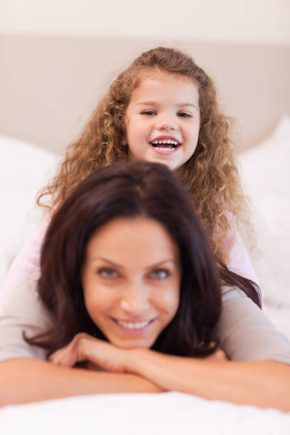 istock Girl sitting on her mothers back 828167604
