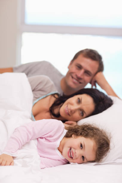 istock Family lying on the bed together 828168118