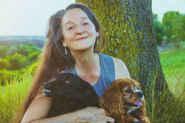 istock Active senior woman hugs dog 828172424
