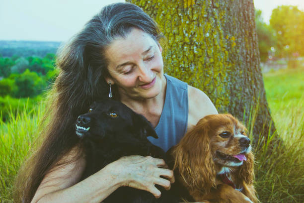 istock Active senior woman hugs dog 828172678