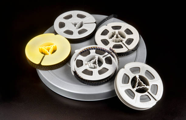 8mm Film Old time 8mm film and film canisters. vintage amateur movie camera stock pictures, royalty-free photos & images