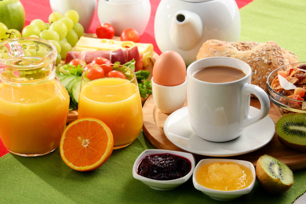 istock Breakfast served with coffee, orange juice, egg and fruits 828190052