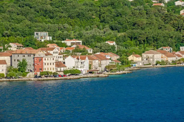 Prcanj - a small town along the Bay of Kotor, Montenegro. A part of the waterfront, that consists of a long line of stone villas.