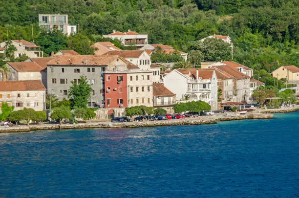 Prcanj - a small town along the Bay of Kotor, Montenegro. A part of the waterfront, that consists of a long line of stone villas.
