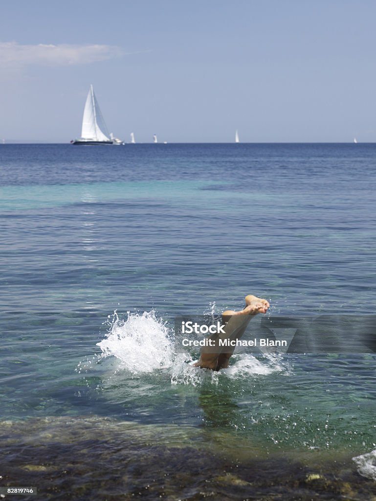 Man dives into the sea  Diving Into Water Stock Photo