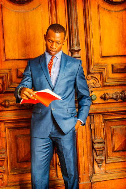 istock African American Businessman reading red book. 828200382