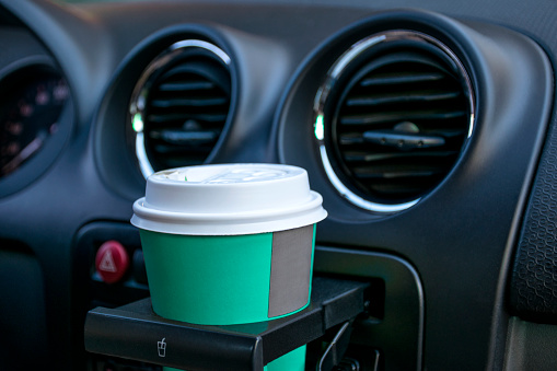 Paper coffee cups inside car cup holder