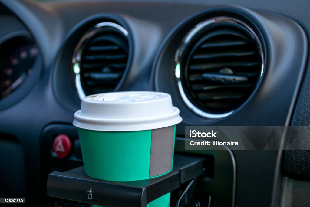 Paper coffee cups inside car cup holder Car Stock Photo