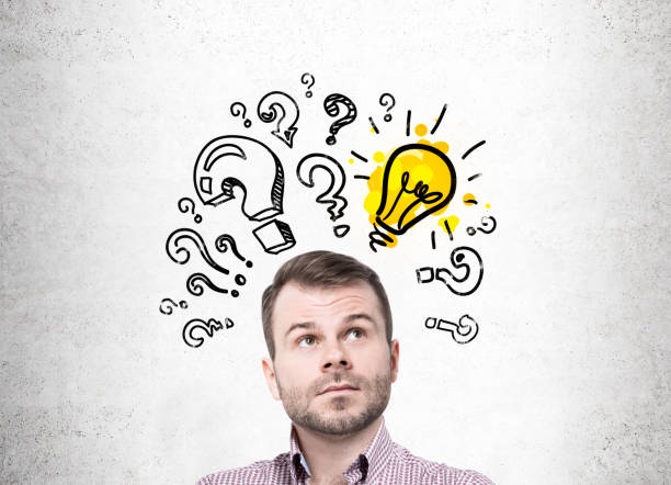 istock Pensive bearded man and light bulb questions 828205224