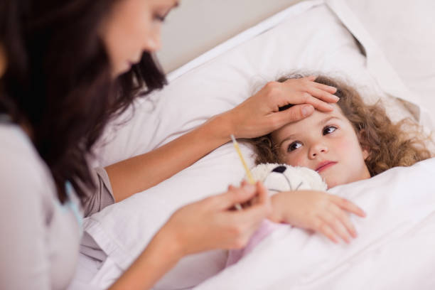 istock Mother taking care of her sick daughter 828209210