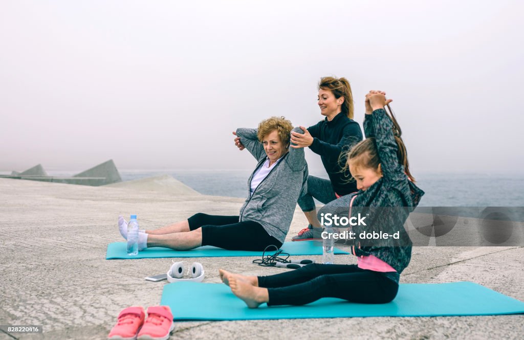 Three female generations exercising Three female generations exercising by sea pier Sport Stock Photo