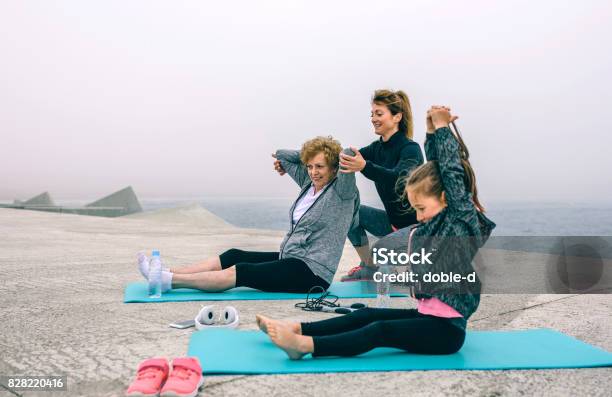 Three Female Generations Exercising Stock Photo - Download Image Now - Sport, Child, Exercising