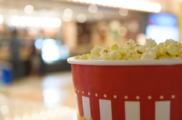 We are waiting with popcorn before the movie starts. stock photo