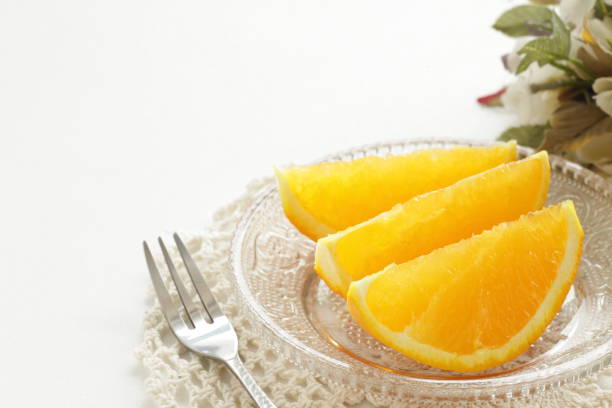 istock cut orange on glass dish 828229428