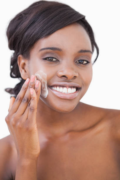 istock Smiling woman putting on cream 828232440