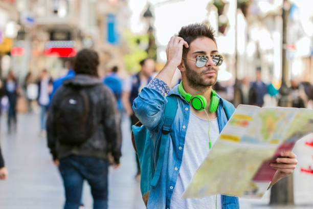 istock Young male tourist lost and looking around 828236488