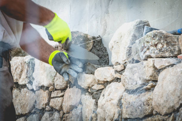 istock worker rides a stone wall on a traditional renovation site 828239376